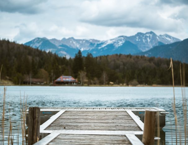 A pier leads out to the Lautersee near Mittenwald in the Bavarian Alps. Perfect concept for outdoor or hiking advertising